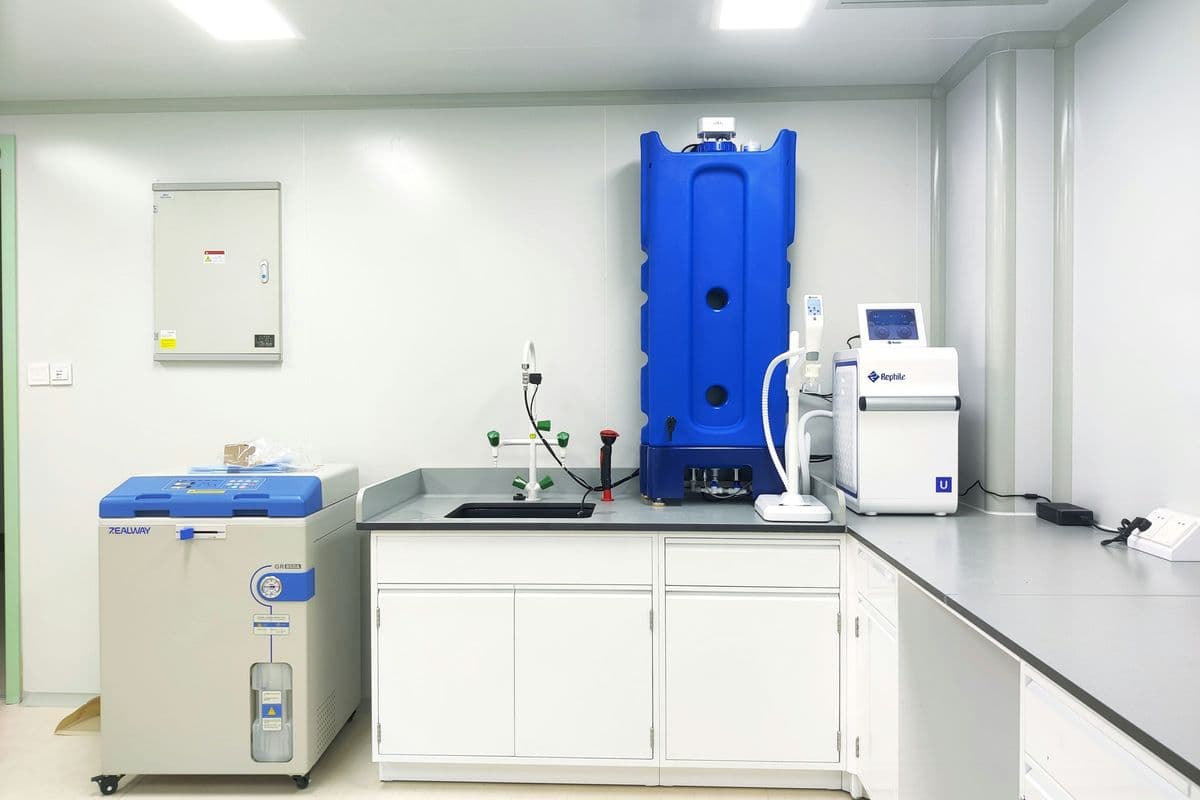 Newly fitted bright laboratory with white benches, a sink, an autoclave and a water purifier