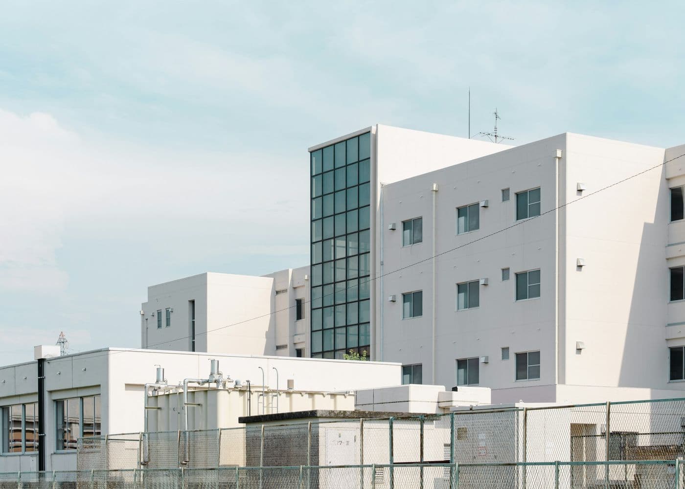 Modern white medical building with a glass stairwell