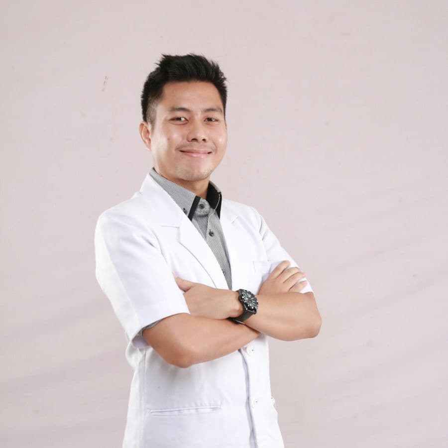 Smiling healthcare professional in a white coat